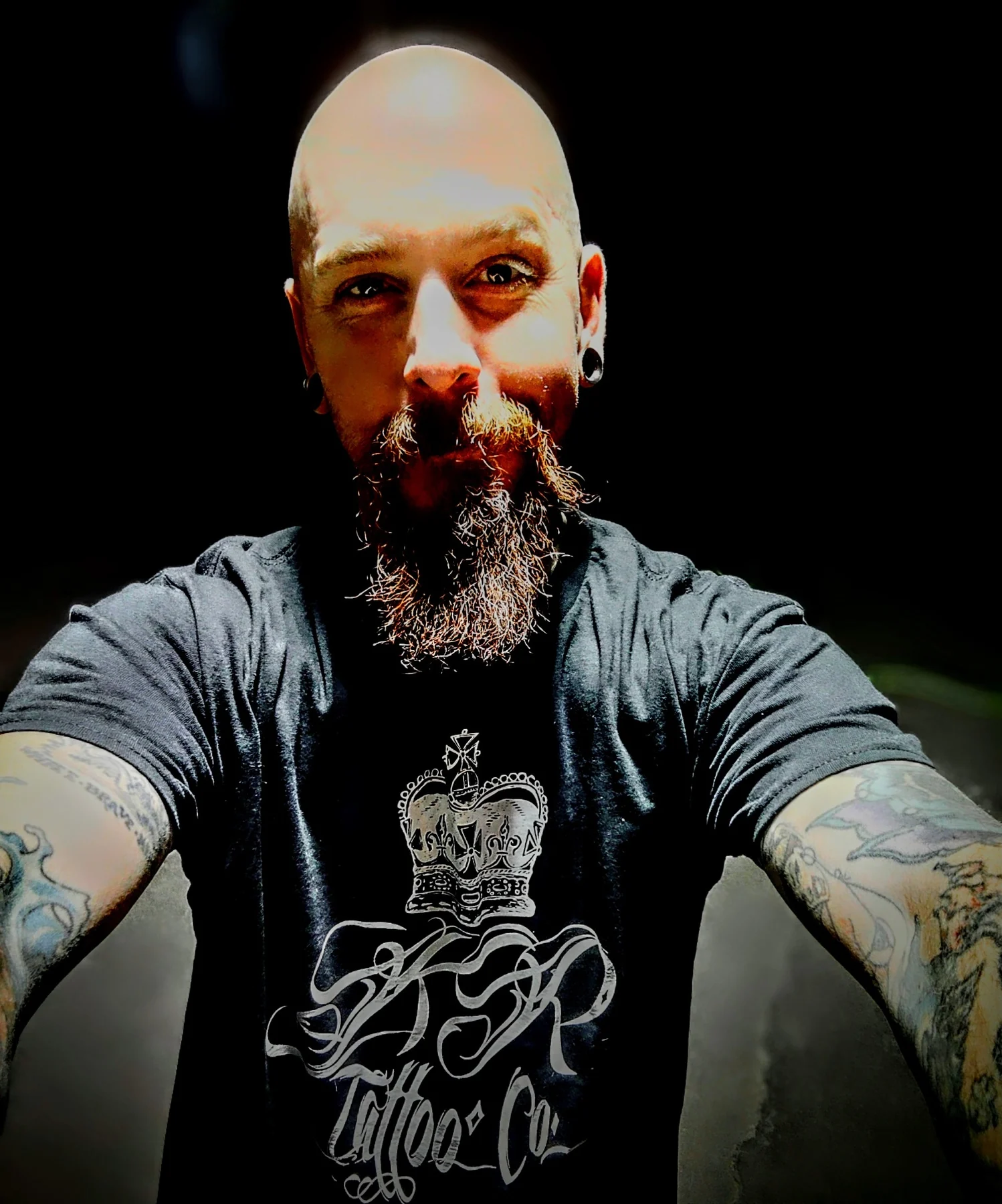 Garrett Hyde in an artist portrait wearing an IKON Tattoo shirt